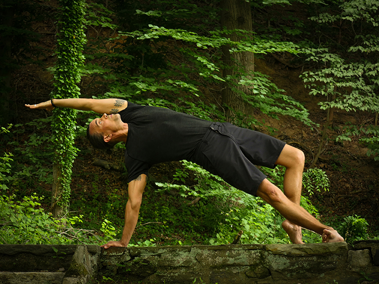 Man practicing yoga in nature